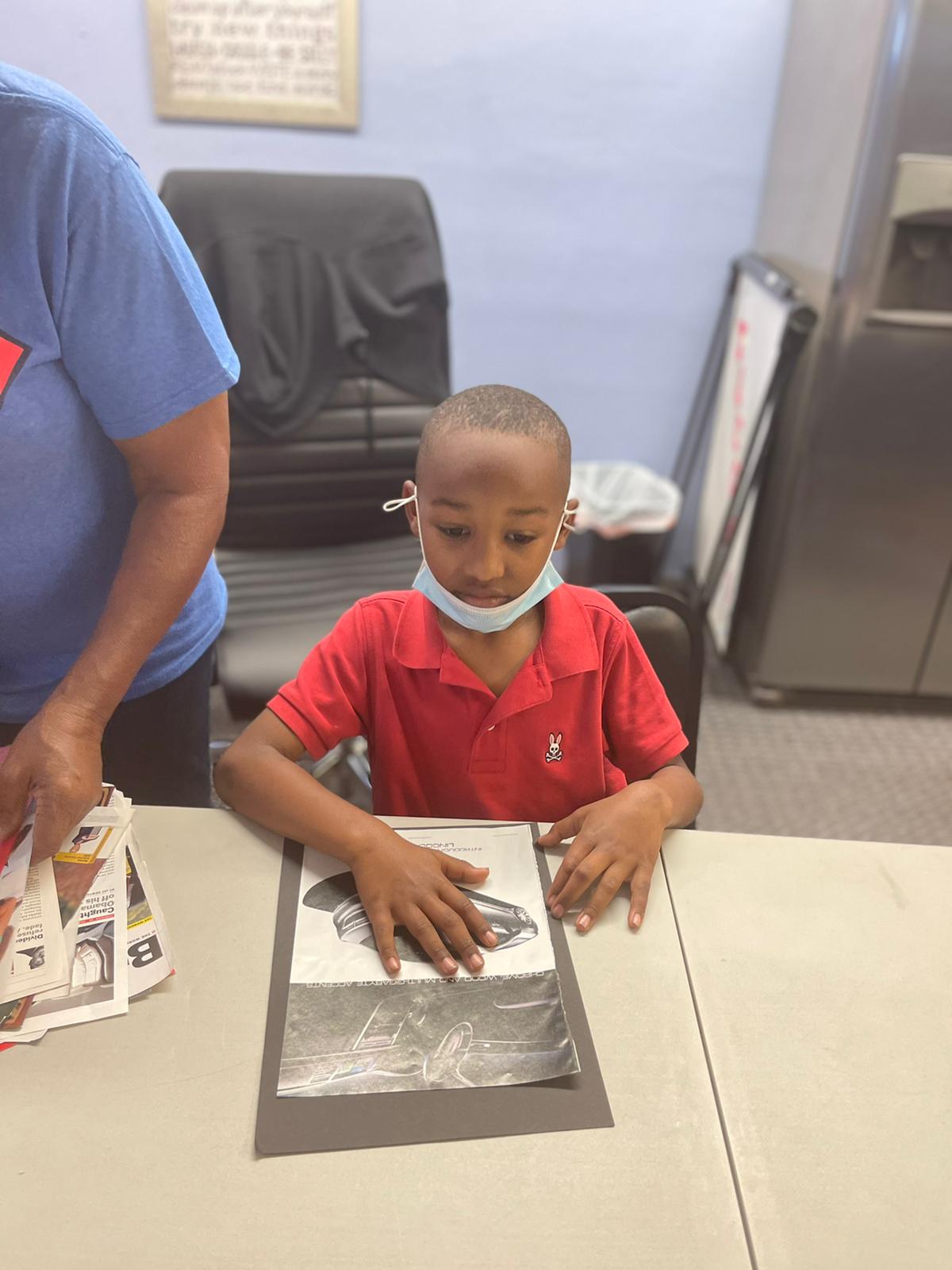 A child creating a personal strengths project during a Federation youth activity