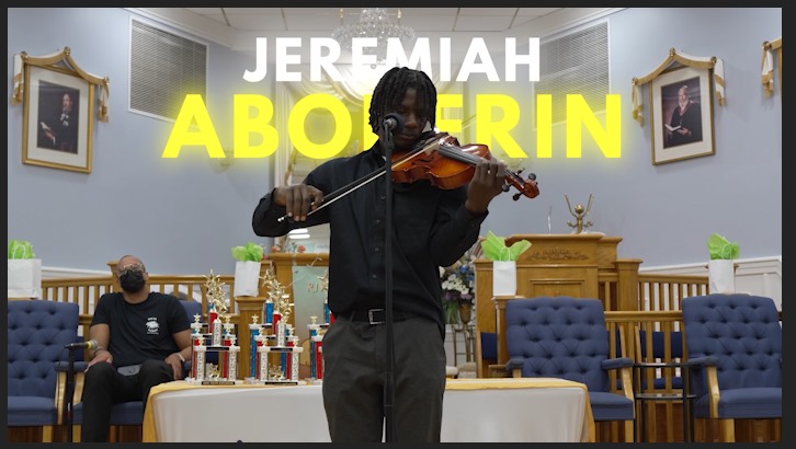 A young violinist performing during a Glades Youth Explosion program